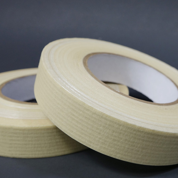 Two rolls of paper filament tape laying on side