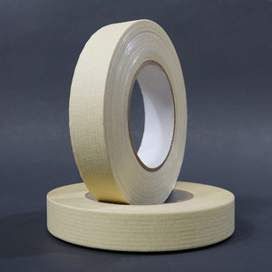 Two rolls of paper filament tape stacked on black background
