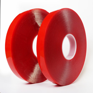 Two rolls of clear high bond tape standing in front of white background