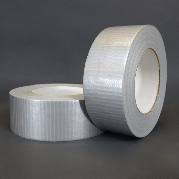 Two rolls of silver duct tape sitting next to each other on a grey background