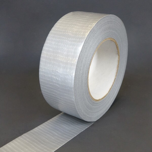 A roll of silver duct tape with a white core, slightly unwound to highlight the cloth backing