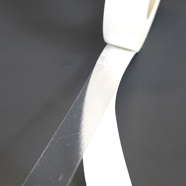 BT-246 roll of tape partially unwound to show adhesive seperated from liner