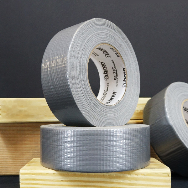 Grey rolls of duct tape stacked on wooden blocks