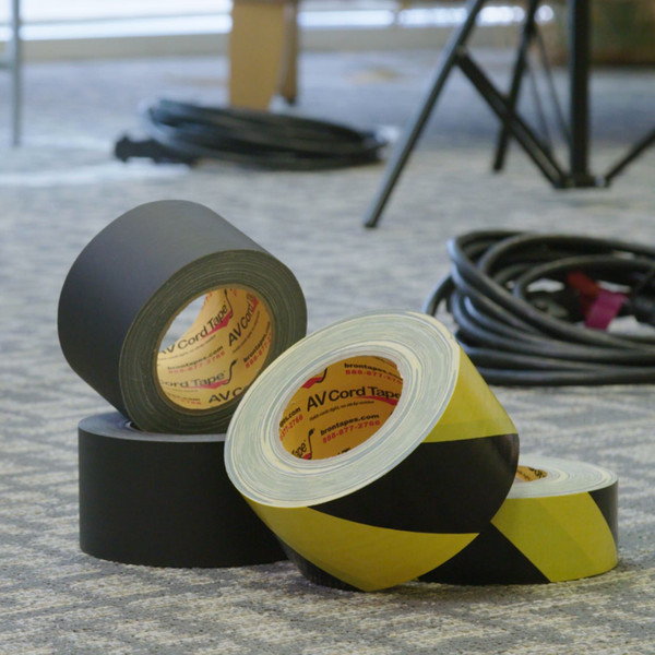 Bron AV Cord Tape in black and hazard stripe displayed with audio visual cords in background
