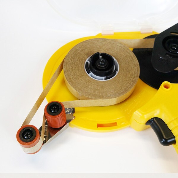 Roll of adhesive transfer tape loaded in yellow adhesive transfer tape dispenser