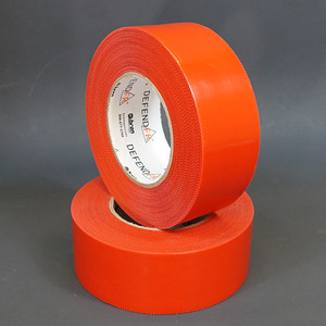 Stacked rolls of red DefendFR polyethylene tape