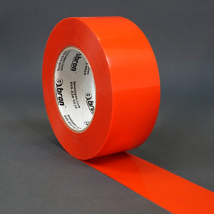 Red roll of polyethylene tape slightly unwound to show the backing of the tape