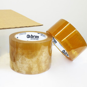 Two rolls of carton sealing tape sitting on top of cardboard box
