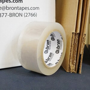 Roll of carton sealing tape next to packaging materials