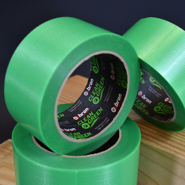 Rolls of Clean Green duct tape displayed on wood in front of black background