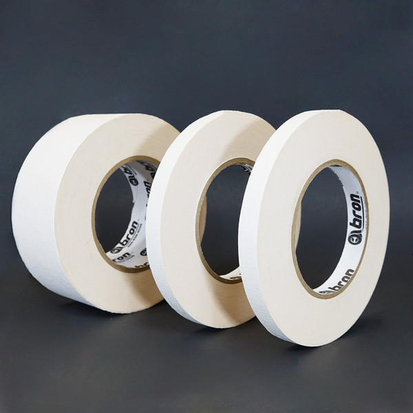 Three rolls of white golf grip tape in different sizes displayed in front of black background