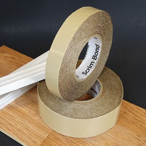 Scrim-Bond scrim tape show on top of flooring materials with black background