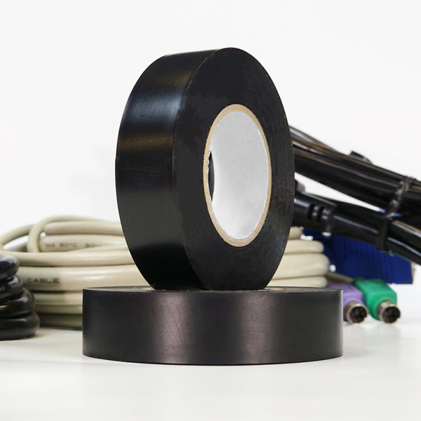 Two rolls of black electrical tape stacked, in front of bundle of cables