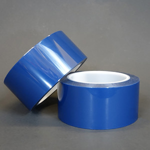 Blue polyester film tape rolls in front of black background