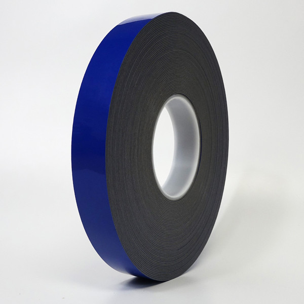 A roll of high bond tape with blue liner standing in front of white background